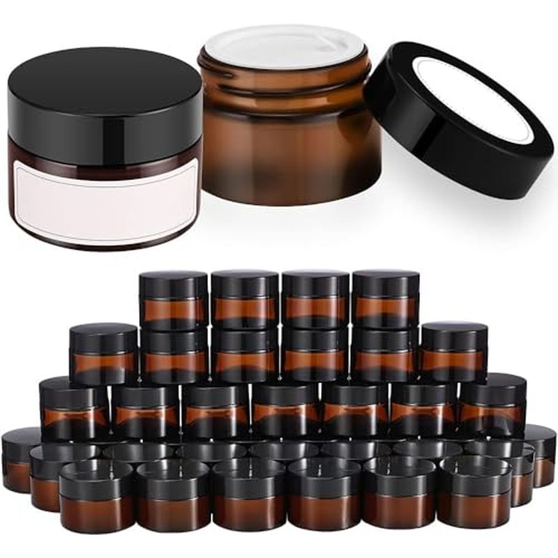 Bumobum 1 oz Amber Glass Jars with Lids, 105 pack Clear Small Jars with Black Lids, White Labels and Inner Liners, Empty Round Cosmetic Containers for Cream, Lotion (Amber 105 Pack)