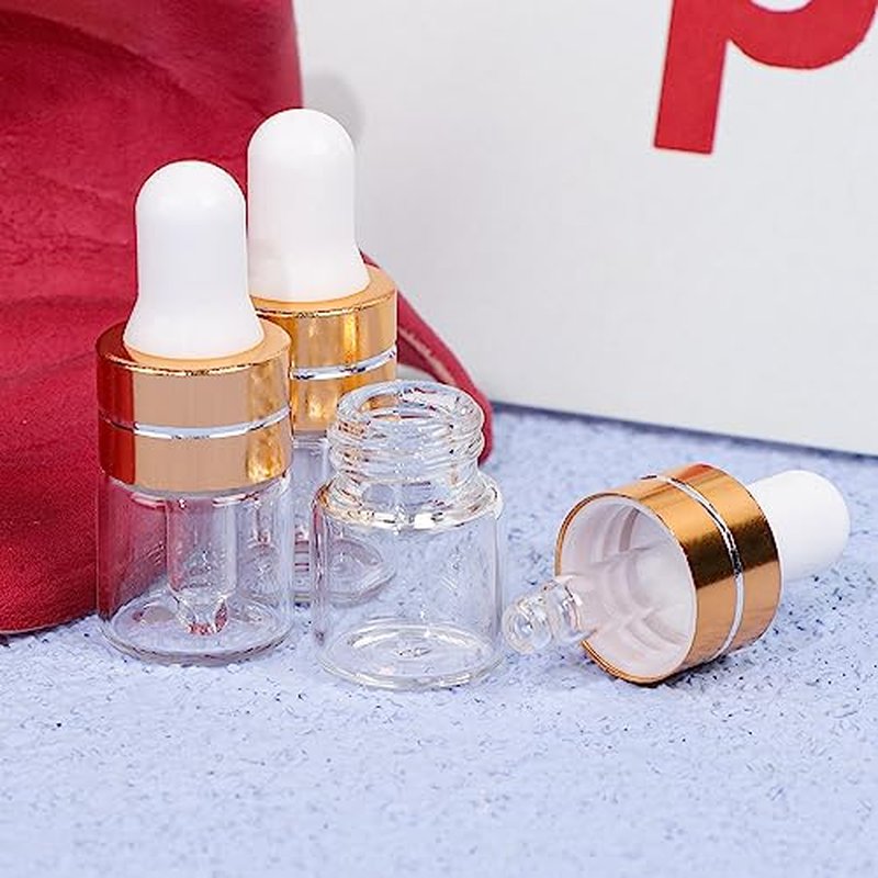 Comrzor 50 Pack 1ml Clear Glass Dropper Bottles with 2 Pcs Plastic Droppers, Mini Sample Dropper Bottles for Essential Oils Perfume Cosmetic Liquid, Empty Travel Sample Vials with Gold Cap